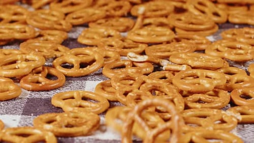 Falling Pretzels on Checkered Table Background