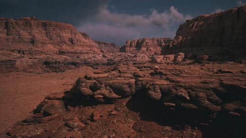 Dramatic Landscape of Rugged Rock Formations Under a Cloudy Sky at Dusk