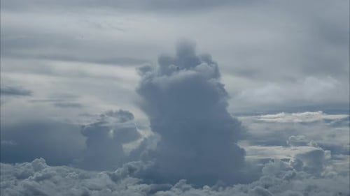 Aerial view of beautiful sky with clouds and sun on a summer day.