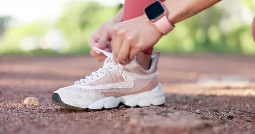 Exercise, hands and tying shoes outdoor for running, fitness and workout at a park
