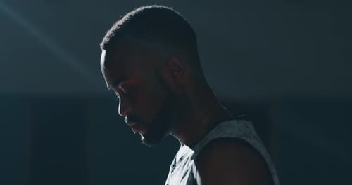 Cinematic slow motion close up shot of a professional young african man is practicing basketball w
