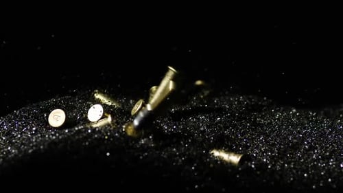 .22 Lange Gewehrkugeln, die in Kugelkörner fallen. Zeitlupe, Zoom-in-Aufnahme