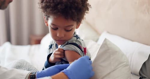 Young Boy Receives Vaccination from Doctor