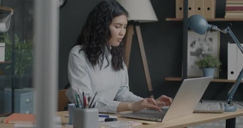 Portrait of Beautiful Young Employee Working in Office Typing with Laptop Developing Business