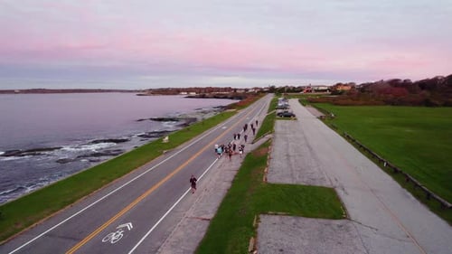 Luftbild von Läufern, die bei Sonnenaufgang am Meer laufen und für ein 10-km-Rennen trainieren. Läufer, Laufstrecke