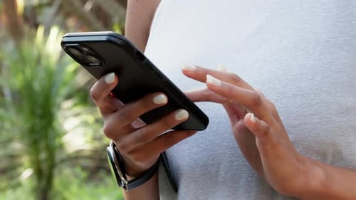 Woman Using Smartphone Outdoors Close Up