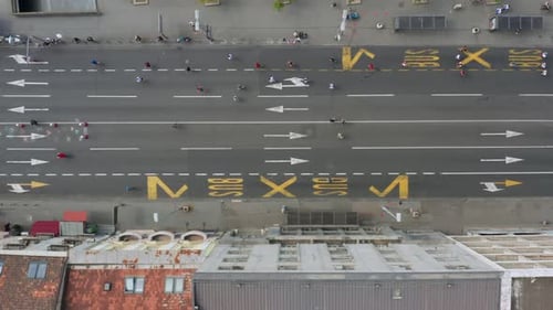 Top View Of Marathon Runners Racing On The City Road In The Morning. aerial
