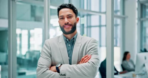 Young Businessman Smiling Confidently in an Office
