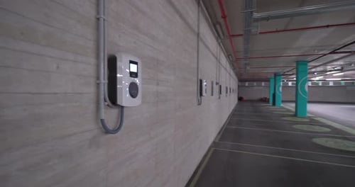 Left to right pan shot Empty Electric Vehicle Charging Spots In A underground Parking Lot