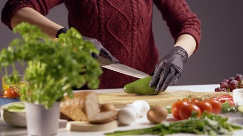 Adult Cutting Avocado on Cutting Board for Meal
