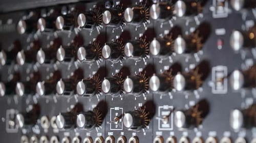 Close up of light changing on audio buttons in professional sound recording studio