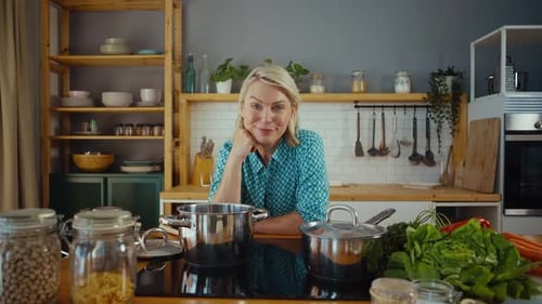 Smiling Woman Posing Near Cooking Ingredients in Kitchen