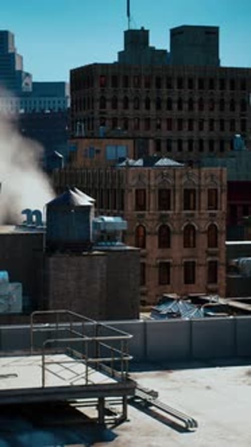 A Cityscape View From a Rooftop with Steam Rising in the Foreground