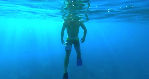 Diver at Surface of Ocean Underwater
