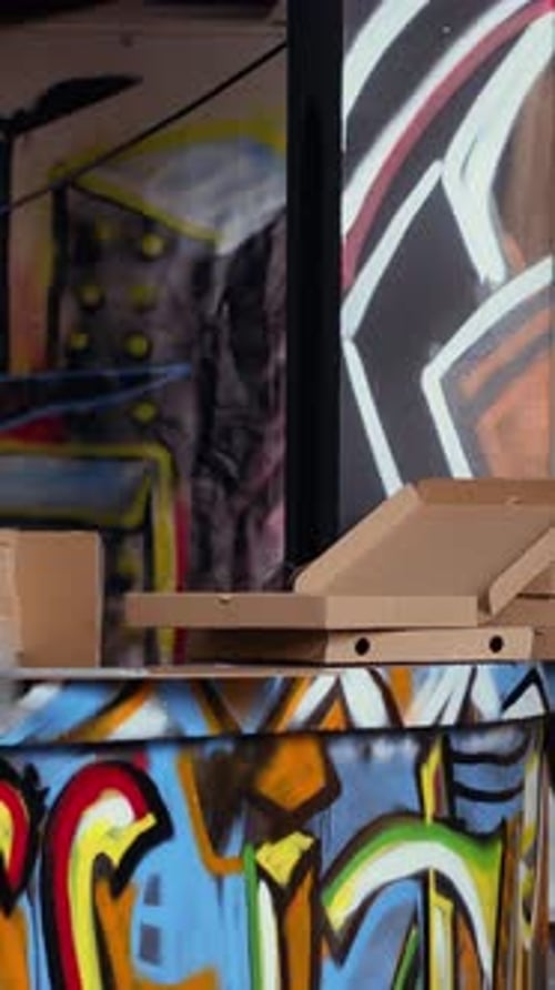 Vertical Video Close Up of Pizza Boxes Leftover By Teenagers in City Suburb Abandoned Building