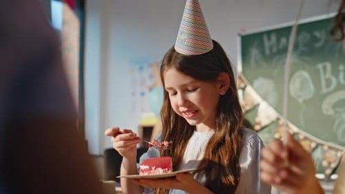 Birthday Girl Eating Cake at School Celebration with Classmates Closeup