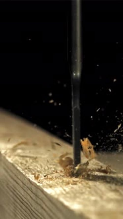 A Carpenter Drills a Hole in a Wooden Product Filmed on a Highspeed Camera at 1000 Fps