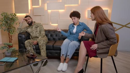 Couple Attends Counseling Session with Therapist in Office