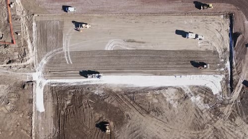 Construction with a bulldozer. View from above. A yellow bulldozer falls to the ground with a bucket