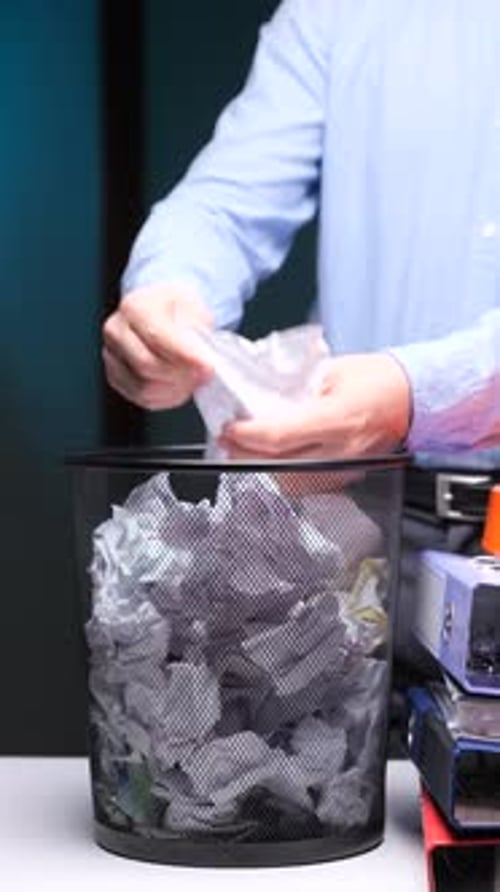 Vertical Video An Office Worker Searches a Discarded Document in a Trash Can