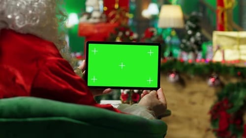 Santa Claus Reads Letters From Kids on Green Screen Tablet