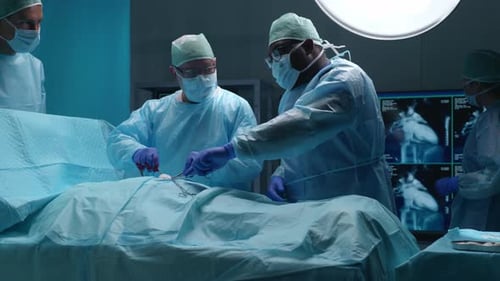 Team of Professional Medical Surgeons Performs the Surgical Operation in a Modern Hospital Doctors