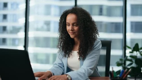 Young Woman Working on Laptop in City Office