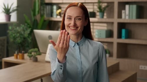 Welcoming Woman Invites You Into the Office