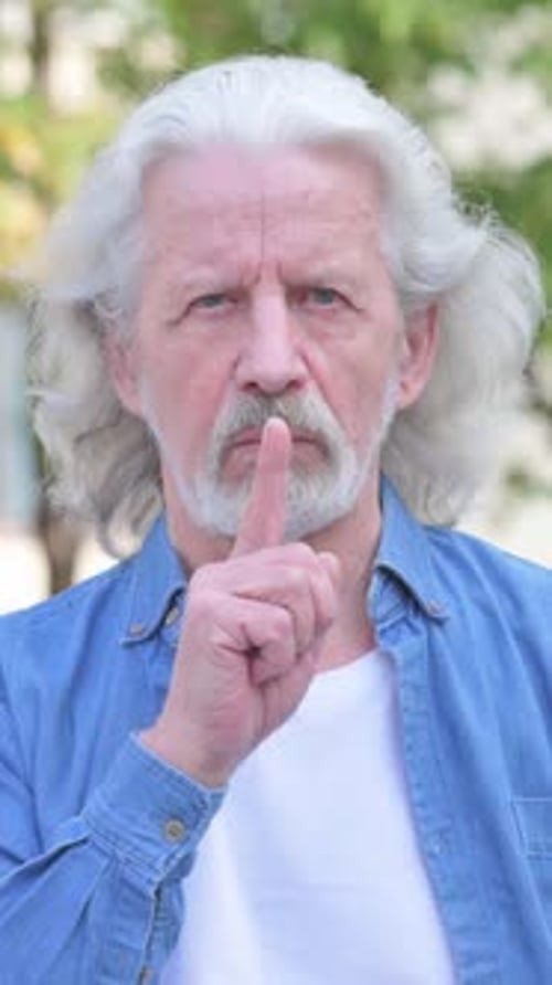 Silence Please Gesture by Old Man Outdoor