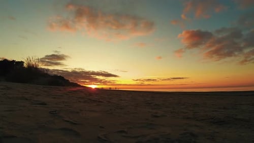 Timelapse Sunset Above Baltic Sea, Latvia. Walking People Silhouette in Background