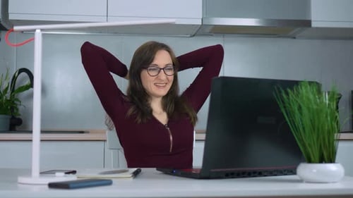 Woman Talking on Laptop from Home Office