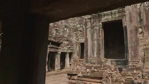Revealing A Large Stone Head While Dollying Out Of A Room In The Angkor Wat Temple. 4K.