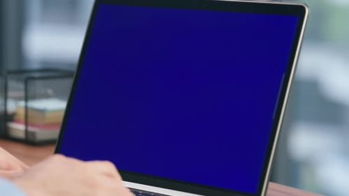 Person Typing on Laptop with Chroma Key Screen