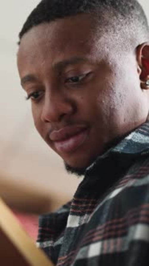 Darkskinned Man Learns Literature in Library