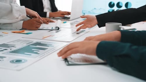 Business Team Analyzing Data Charts in Office Meeting
