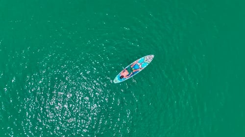 Aerial View Paddleboarding Adventure in the Large Green Canyon People Relax and Enjoy Nature