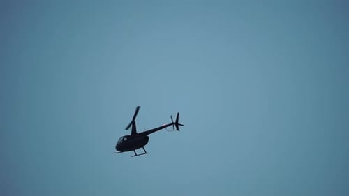 Modern Helicopter Fly in Sky As Viewed From the Ground