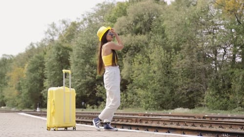 Young Woman with Suitcase at Train Station