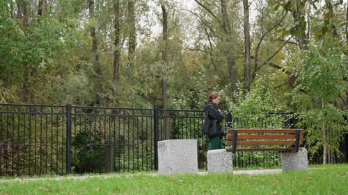 Teenage Girl Walking in Park on Cloudy Day
