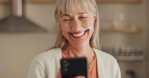 Senior Woman Smiling and Holding a Smartphone