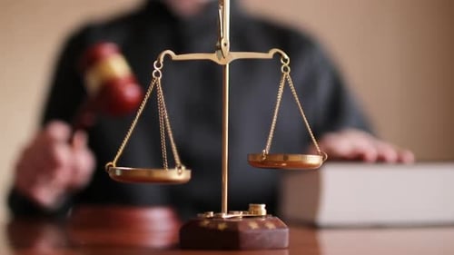 Judge Banging Gavel in the Courtroom Justice Scales on Table Close Up Law Legal System and Justice