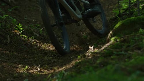 A mountain biker performs a drift in slow motion