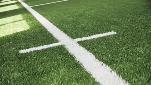 White Marking on Green Artificial Grass of Football Field