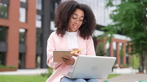 Female Student Studying on Campus with Laptop