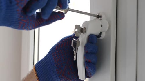 Hand Tightens Window Lock with Screwdriver