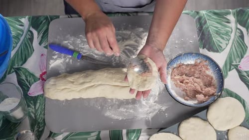 Woman Shaping Dough and Filling Pies with Meat in Cozy Kitchen