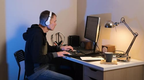 Male Creating Music in a Cozy Home Studio