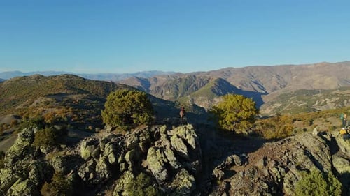 Aerial view of a traveler in nature on a high hill