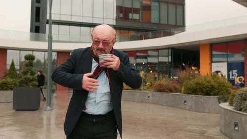 Adult Man Coughing into Scarf Outside