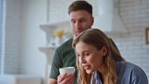 Couple Smiling Together in Modern Kitchen